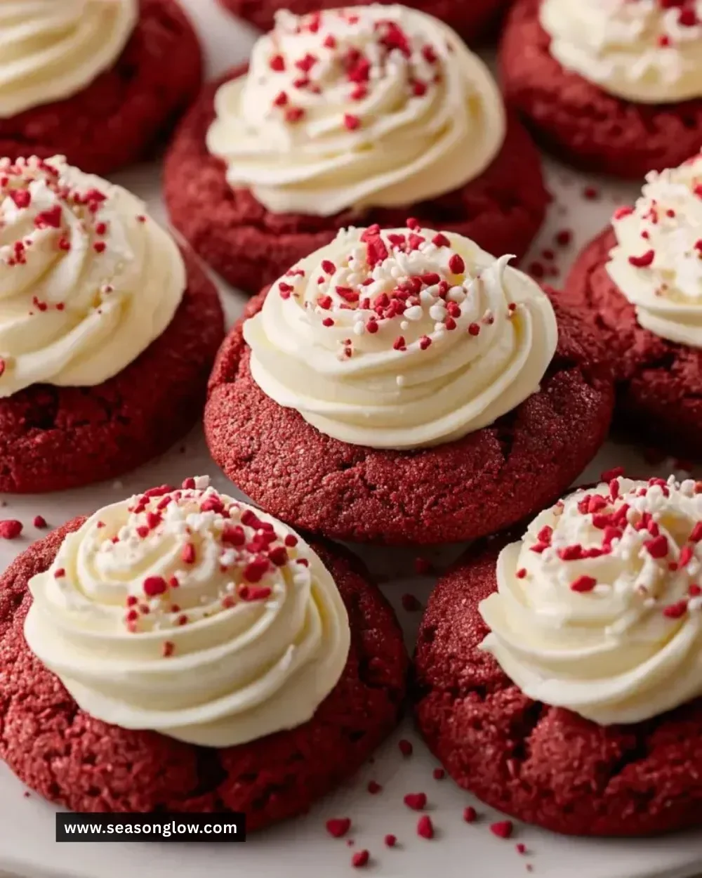 Delicious red velvet cookies with cream cheese frosting on a plate