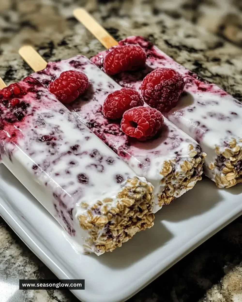 Refreshing mixed berry Greek yogurt pops on a wooden table.
