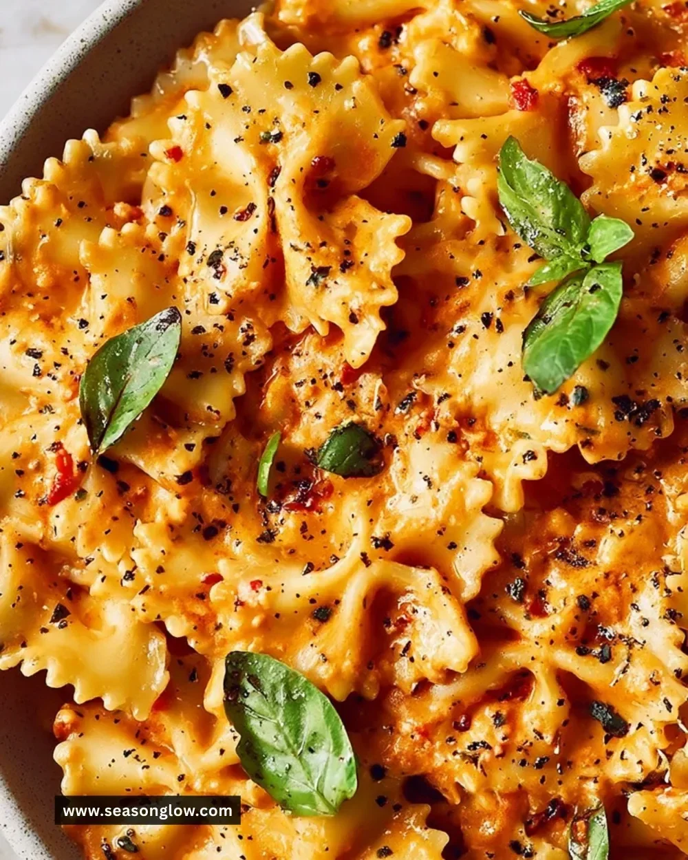 Bowl of speedy sun-dried tomato pasta with fresh herbs and Parmesan cheese
