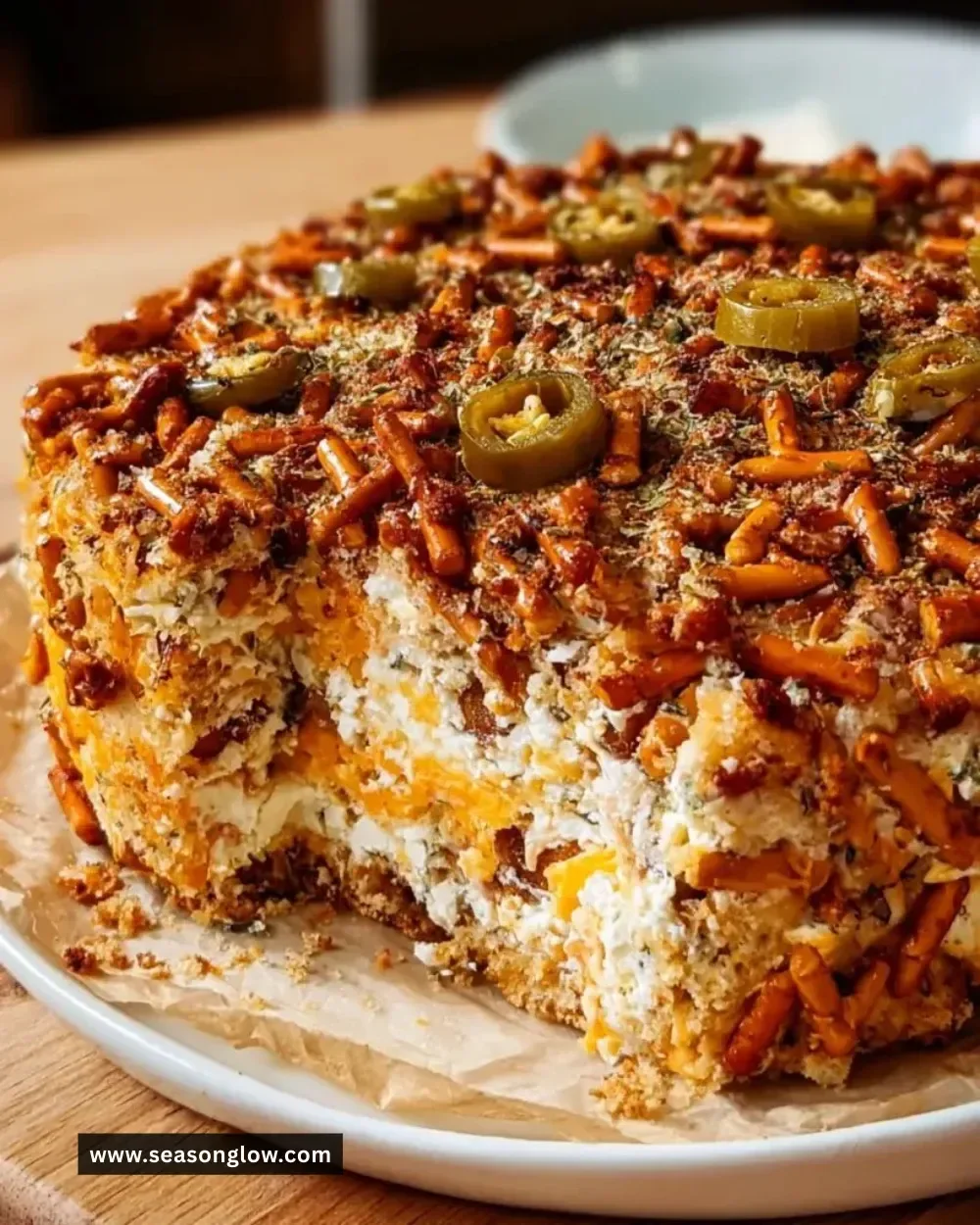 Spicy Ranch Pretzel Chaos Cake topped with ranch seasoning and pretzel pieces.