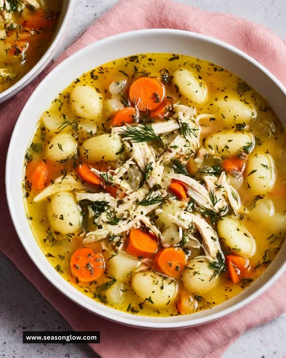 Bowl of Spring Chicken Gnocchi Soup with fresh vegetables and gnocchi