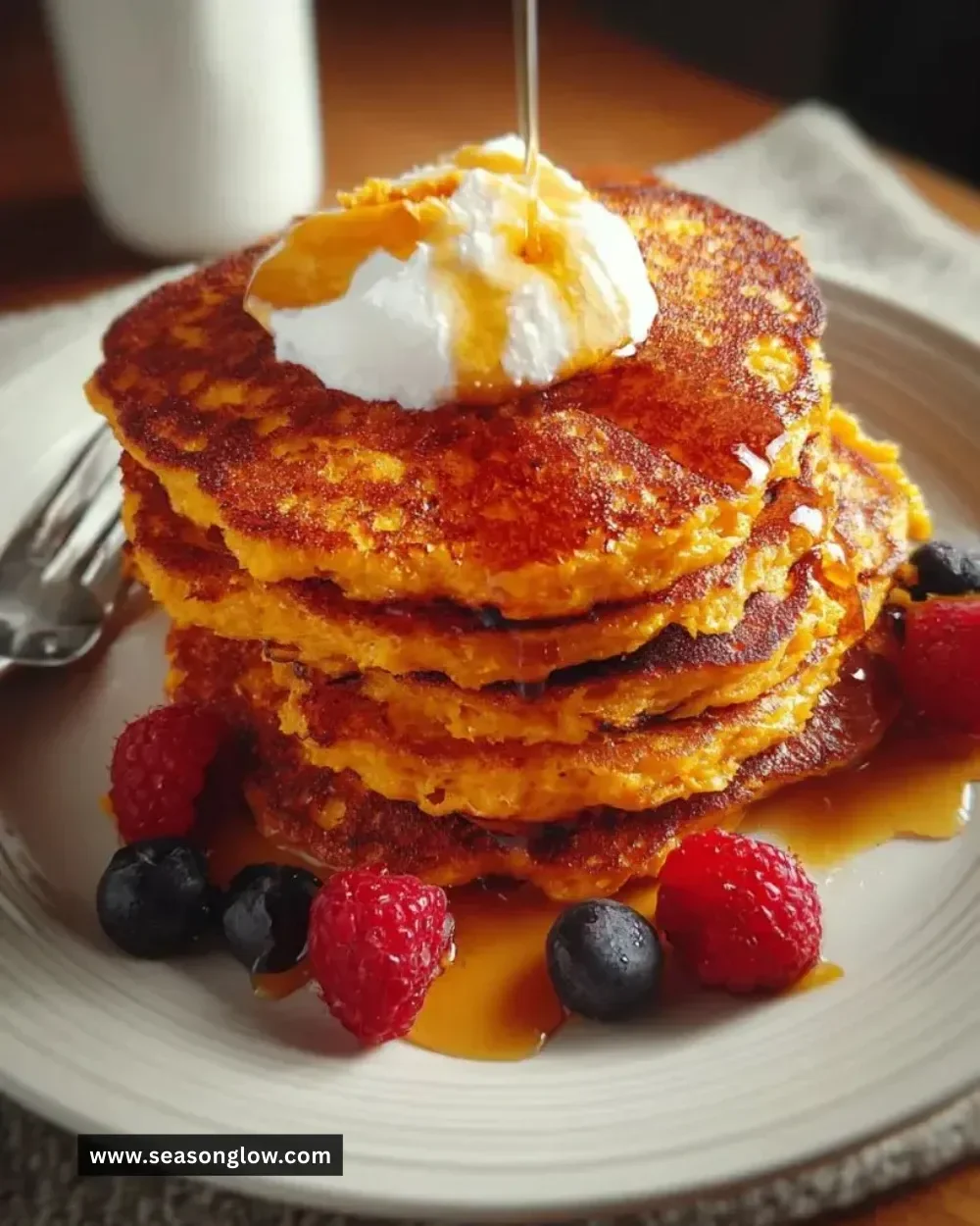 Delicious homemade sweet potato pancakes stacked on a plate with syrup