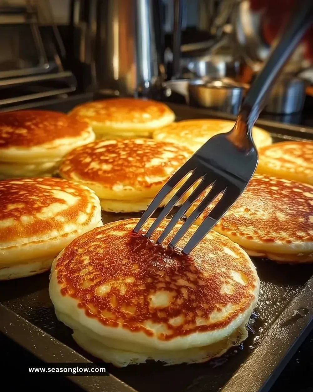 Stack of golden blueberry pancakes topped with fresh berries and syrup