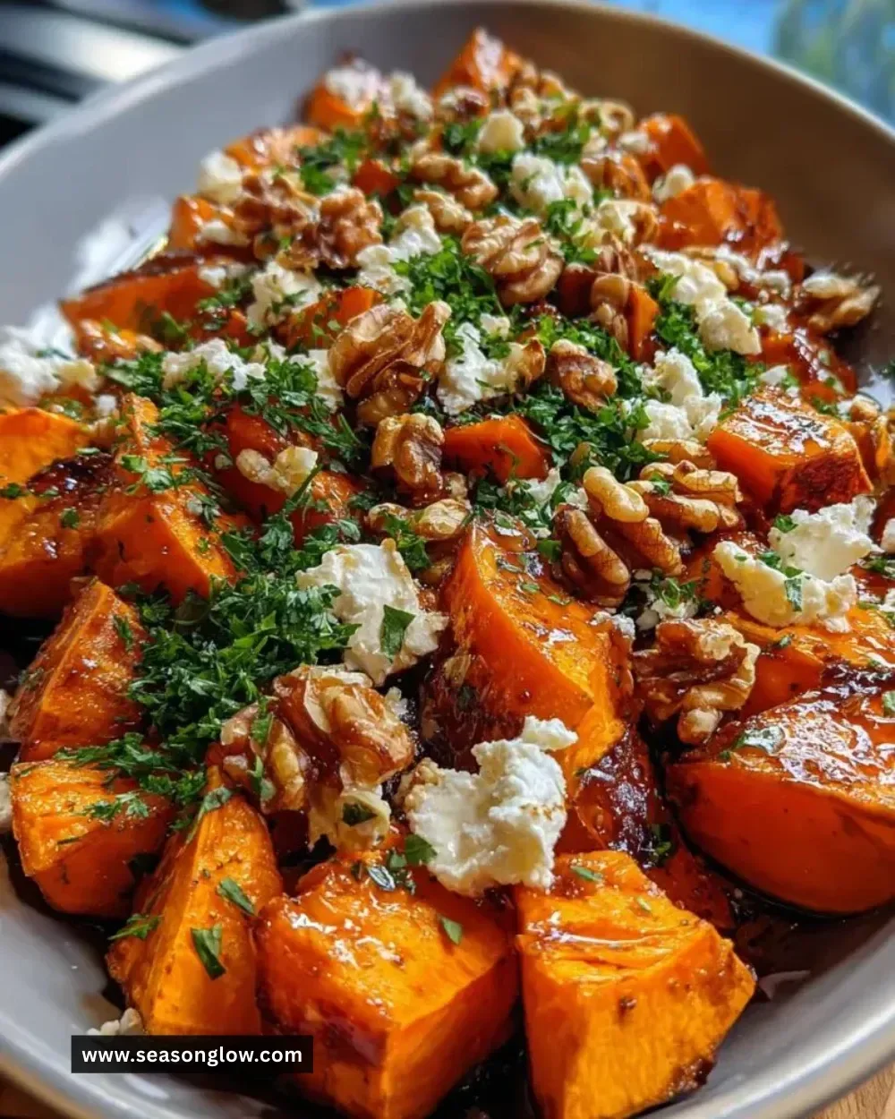 A vibrant Walnut Maple Goat Cheese Salad garnished with nuts and maple dressing