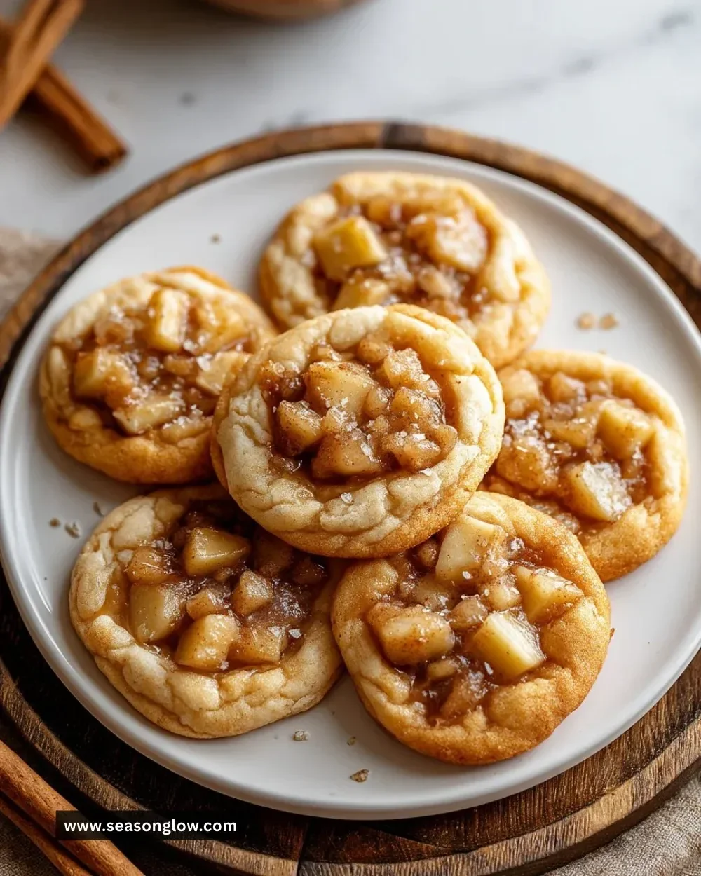 Freshly baked warm and buttery apple pie cookies on a cooling rack.