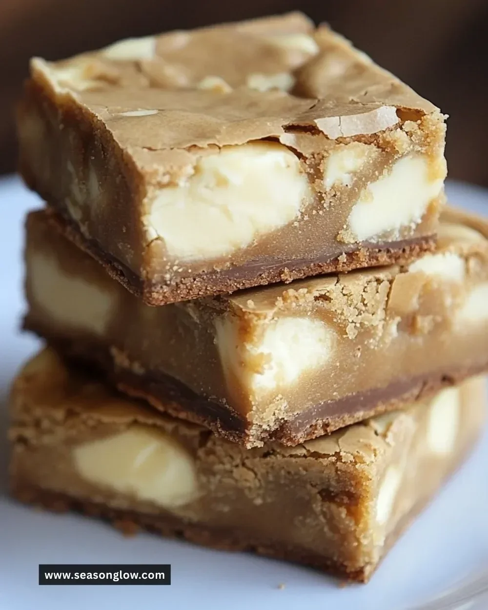 Decadent white chocolate brownies topped with chocolate chips and a sprinkle of sugar.
