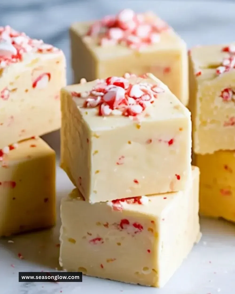 Delicious white chocolate peppermint fudge garnished with peppermint flakes