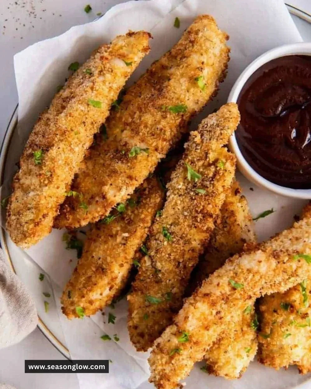 Crispy air fryer chicken tenders served on a plate with dipping sauce