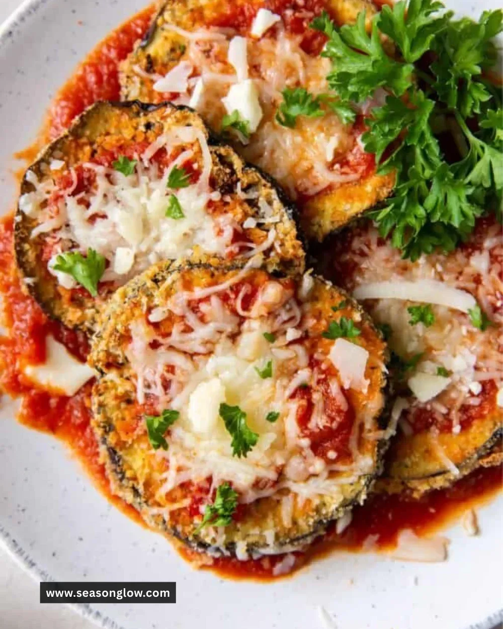 Delicious air fryer eggplant parmesan topped with melted cheese and herbs