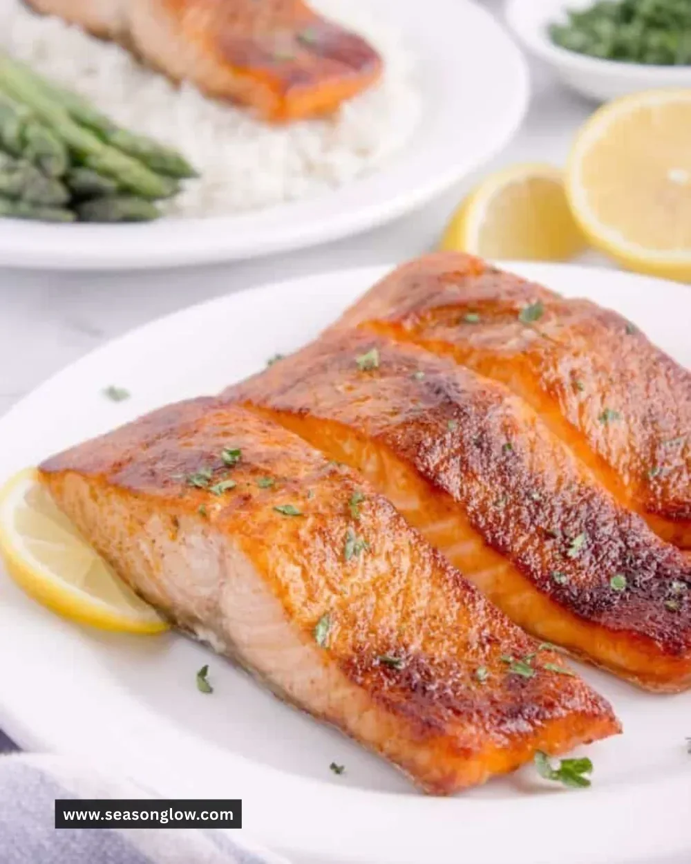Deliciously cooked air fryer salmon fillet served on a plate with lemon.