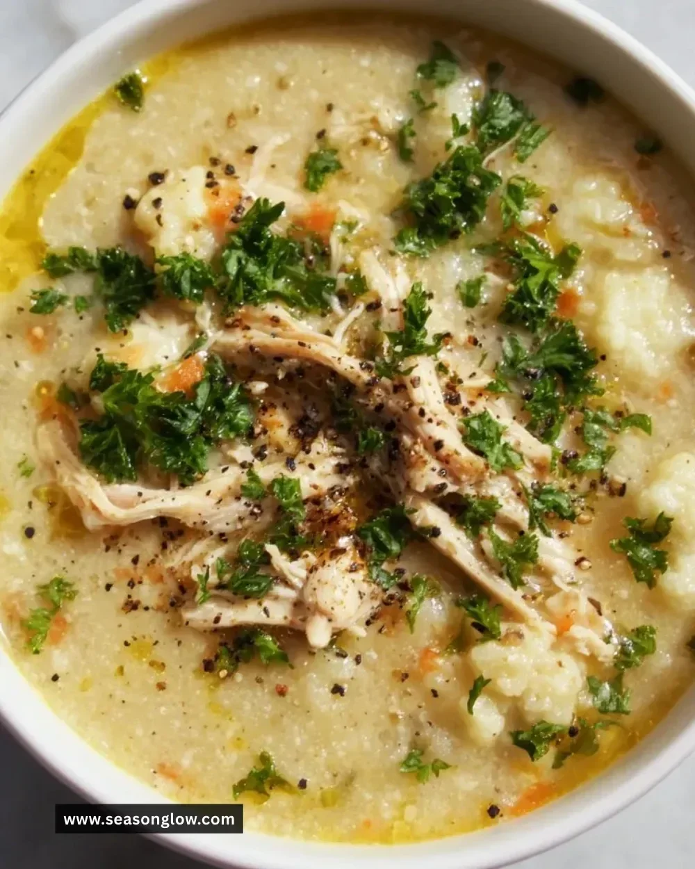 Bowl of anti-inflammatory cauliflower chicken soup garnished with herbs