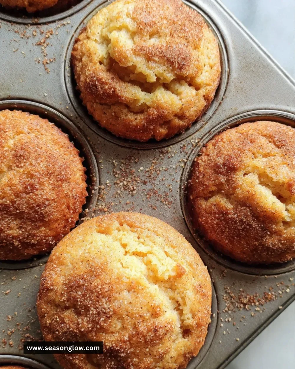 Freshly baked applesauce muffins cooling on a wire rack