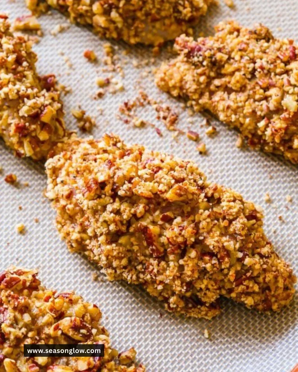 Baked pecan crusted chicken fingers served with a side salad.