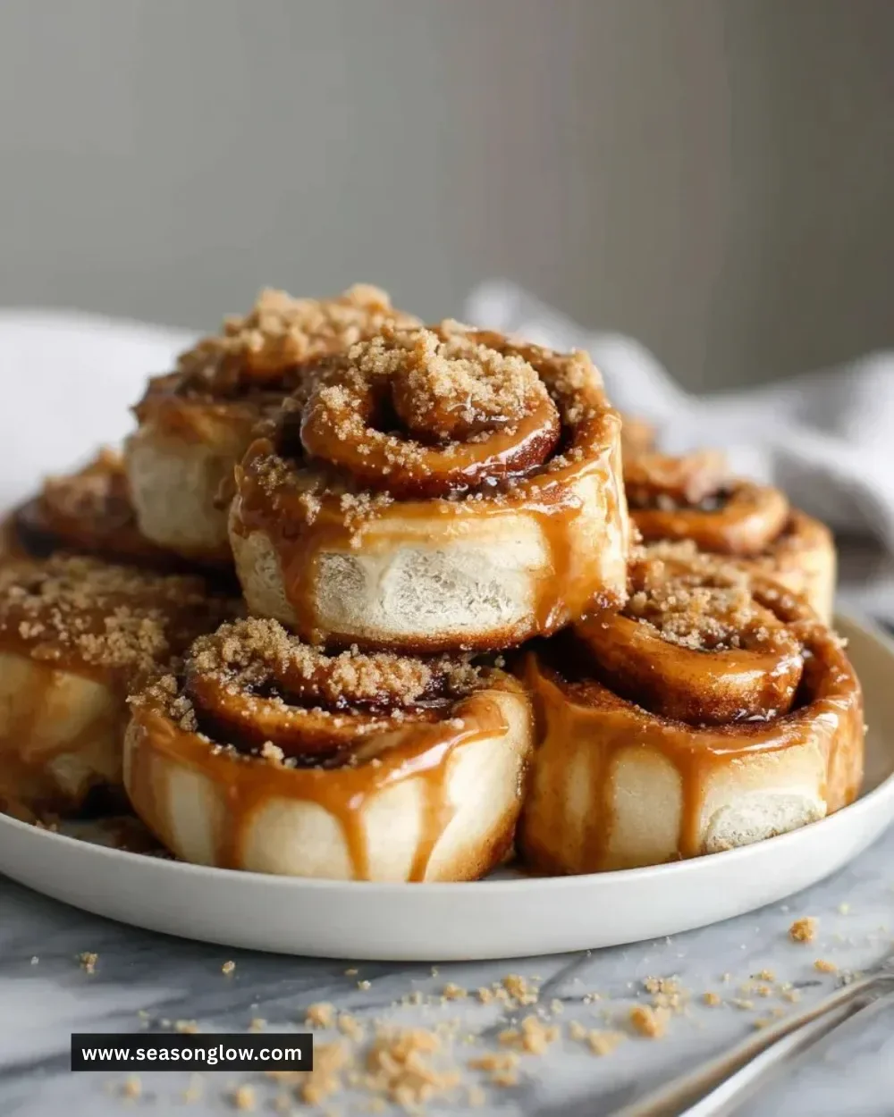 Biscoff cookie butter cinnamon rolls topped with icing.
