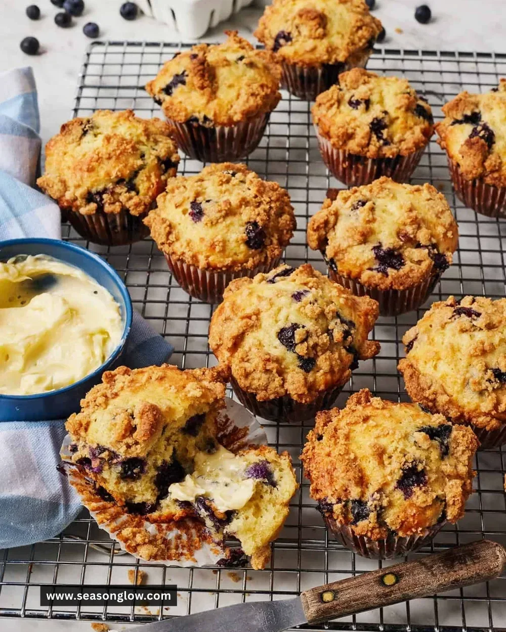 Freshly baked blueberry muffins with juicy blueberries on a wooden table