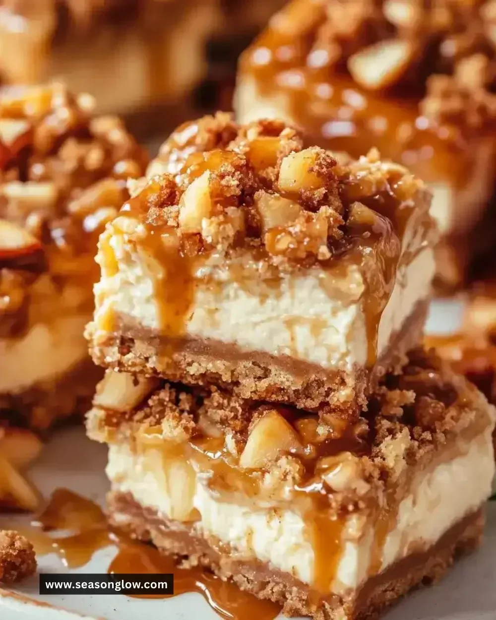 Delicious caramel apple cheesecake bars topped with caramel drizzle and apple slices
