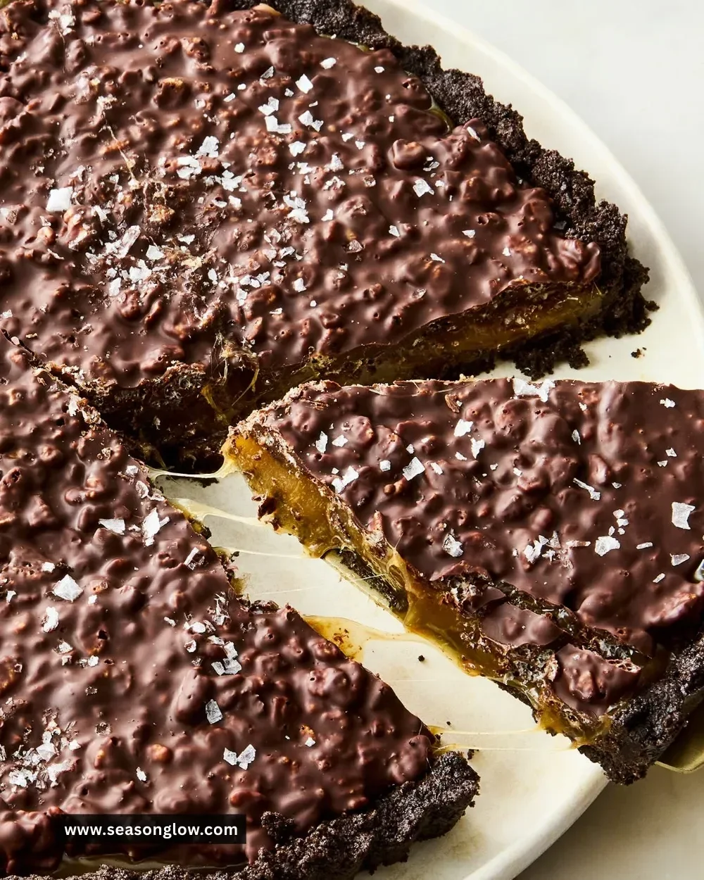 Delicious slice of Caramel Crunch Tart with a crunchy topping and caramel drizzle