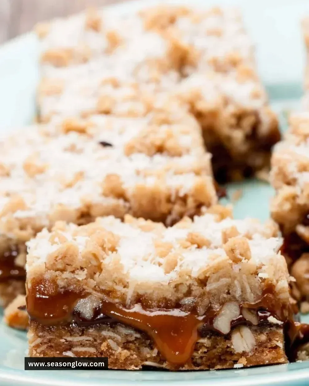 Delicious homemade Carmelita Bars with oats, chocolate, and caramel topping.