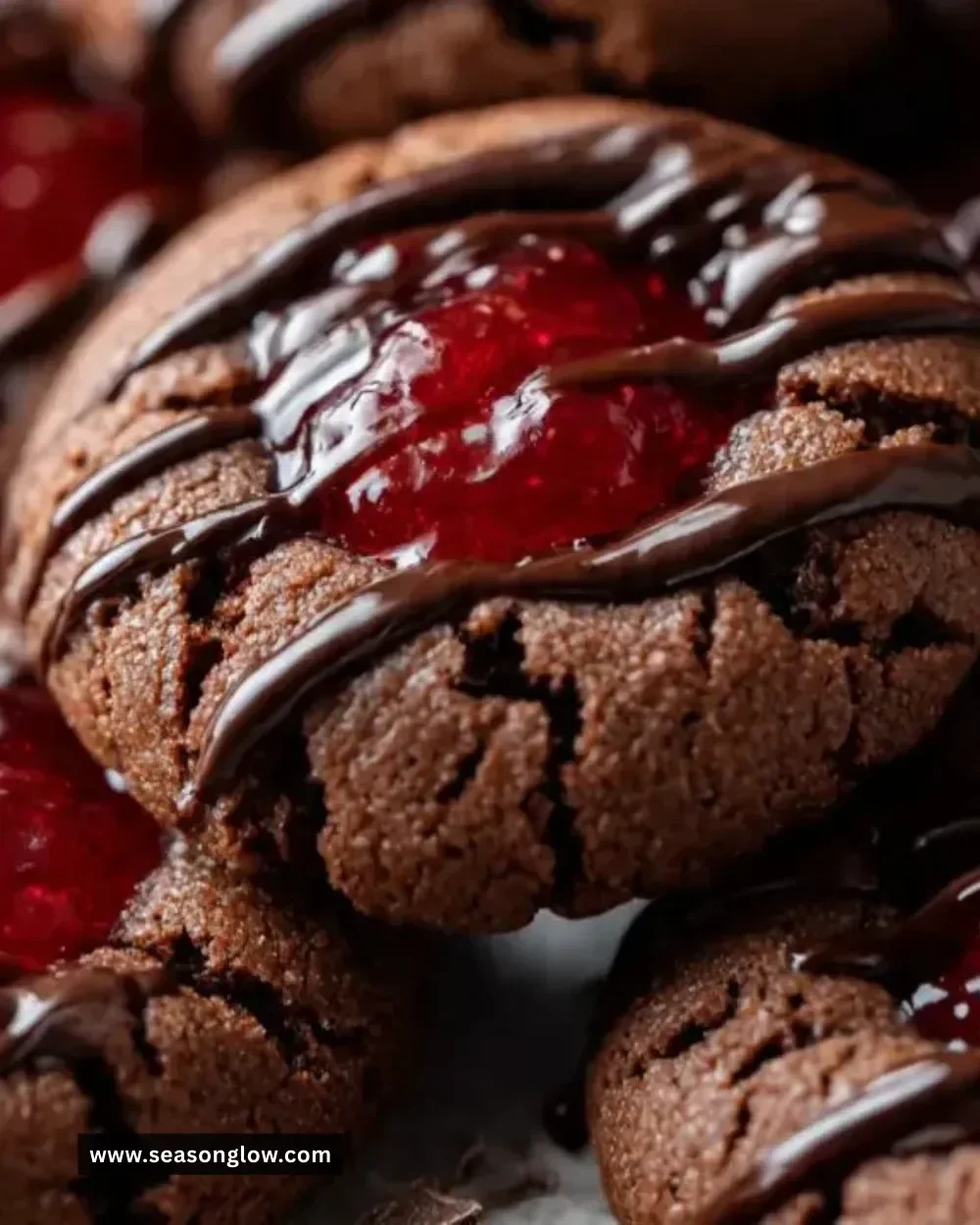 Delicious chocolate cherry thumbprint cookies on a rustic wooden table.