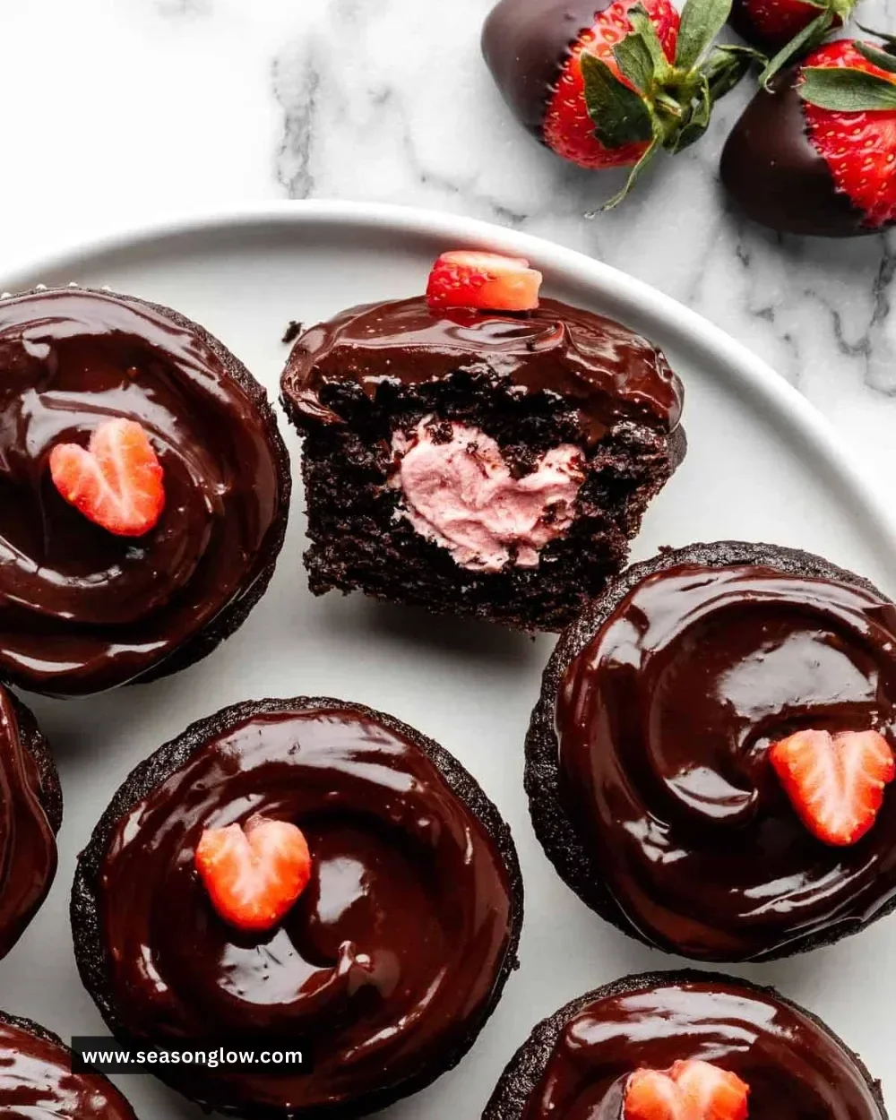 Delicious chocolate covered strawberry cupcakes topped with fresh strawberries