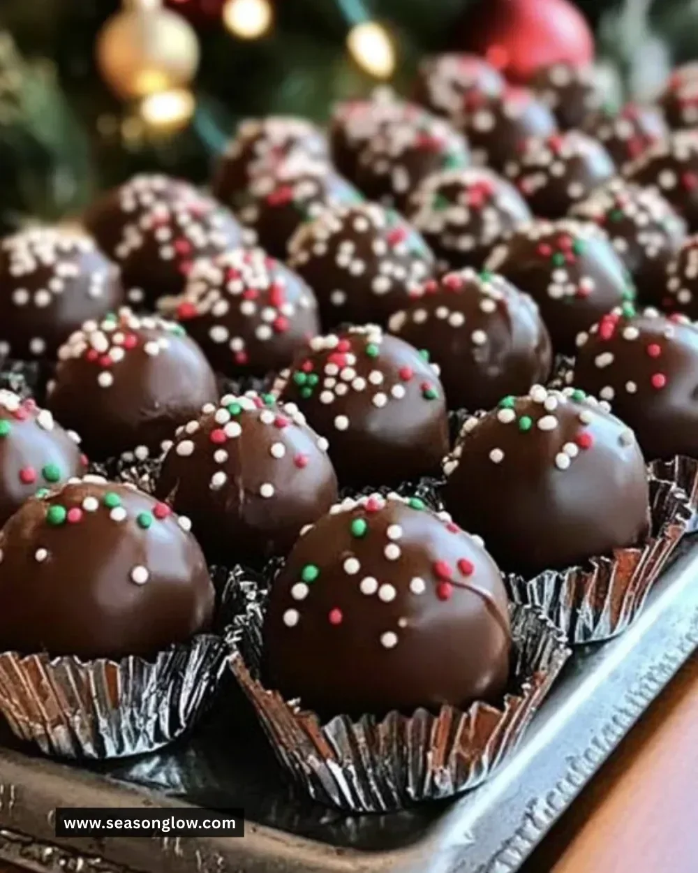 A plate of Christmas Peanut Butter Balls decorated with holiday-themed sprinkles.