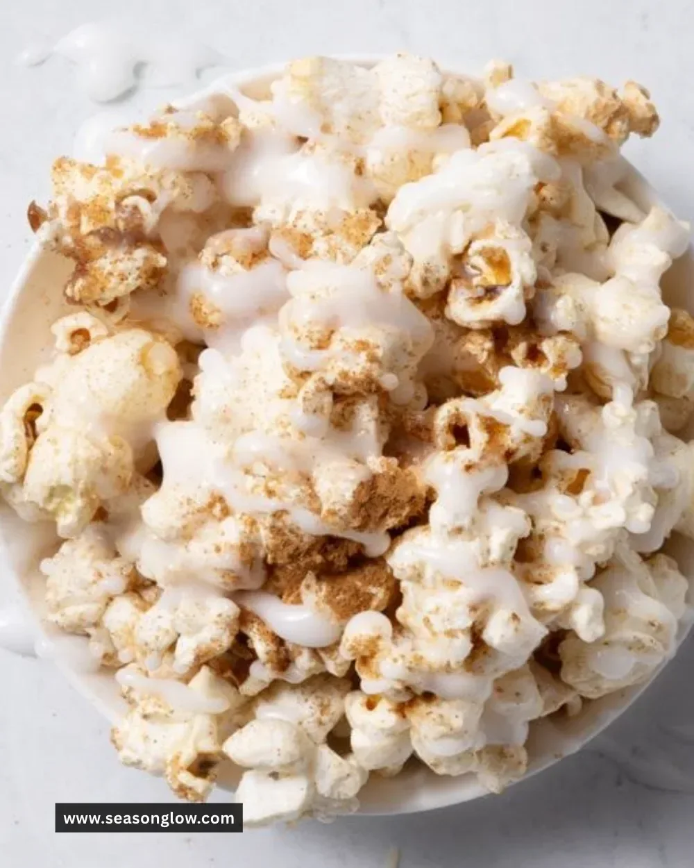 Delicious Cinnamon Bun Popcorn in a bowl, topped with cinnamon and sugar
