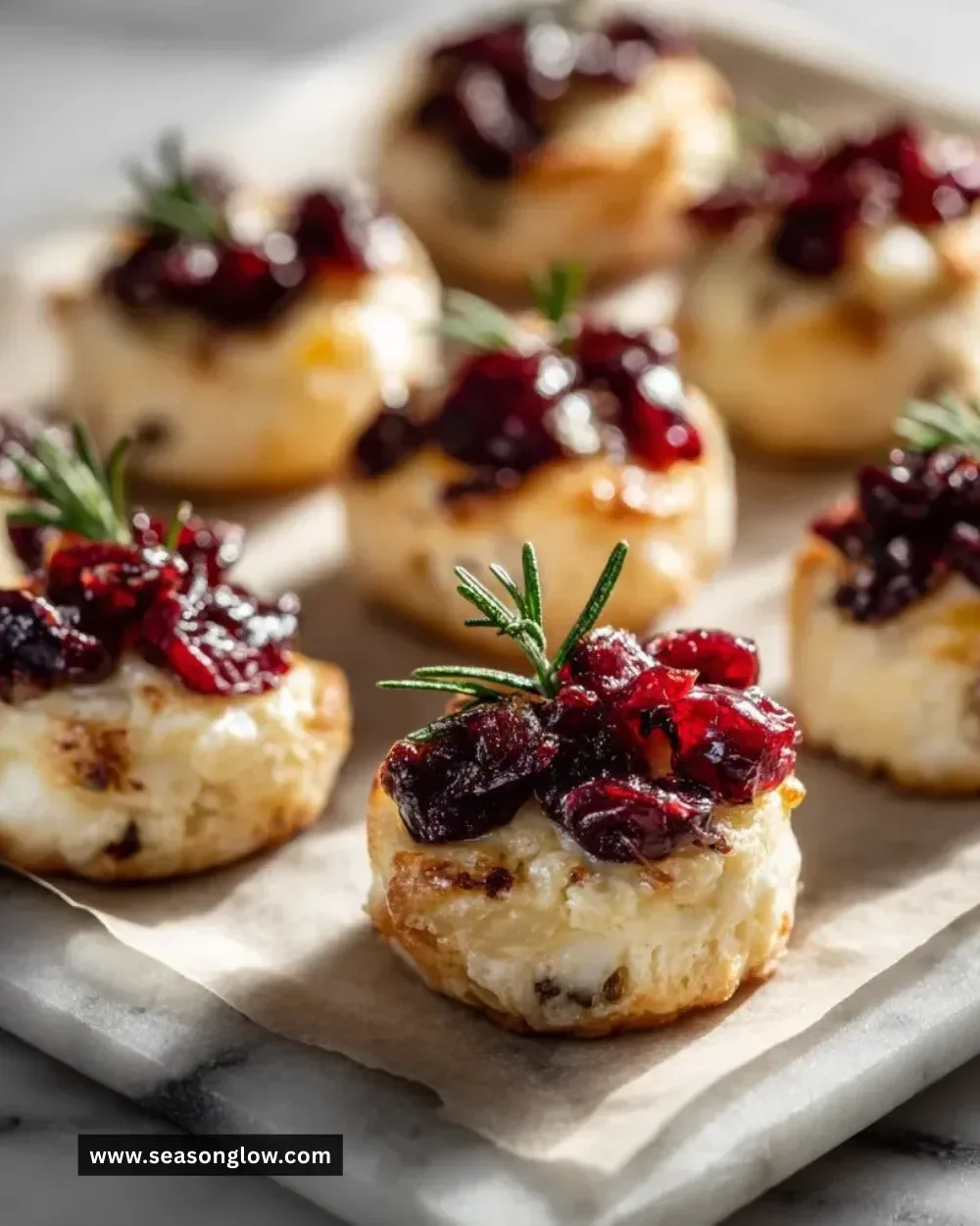 Golden brown Cranberry Brie Bites on a serving platter.