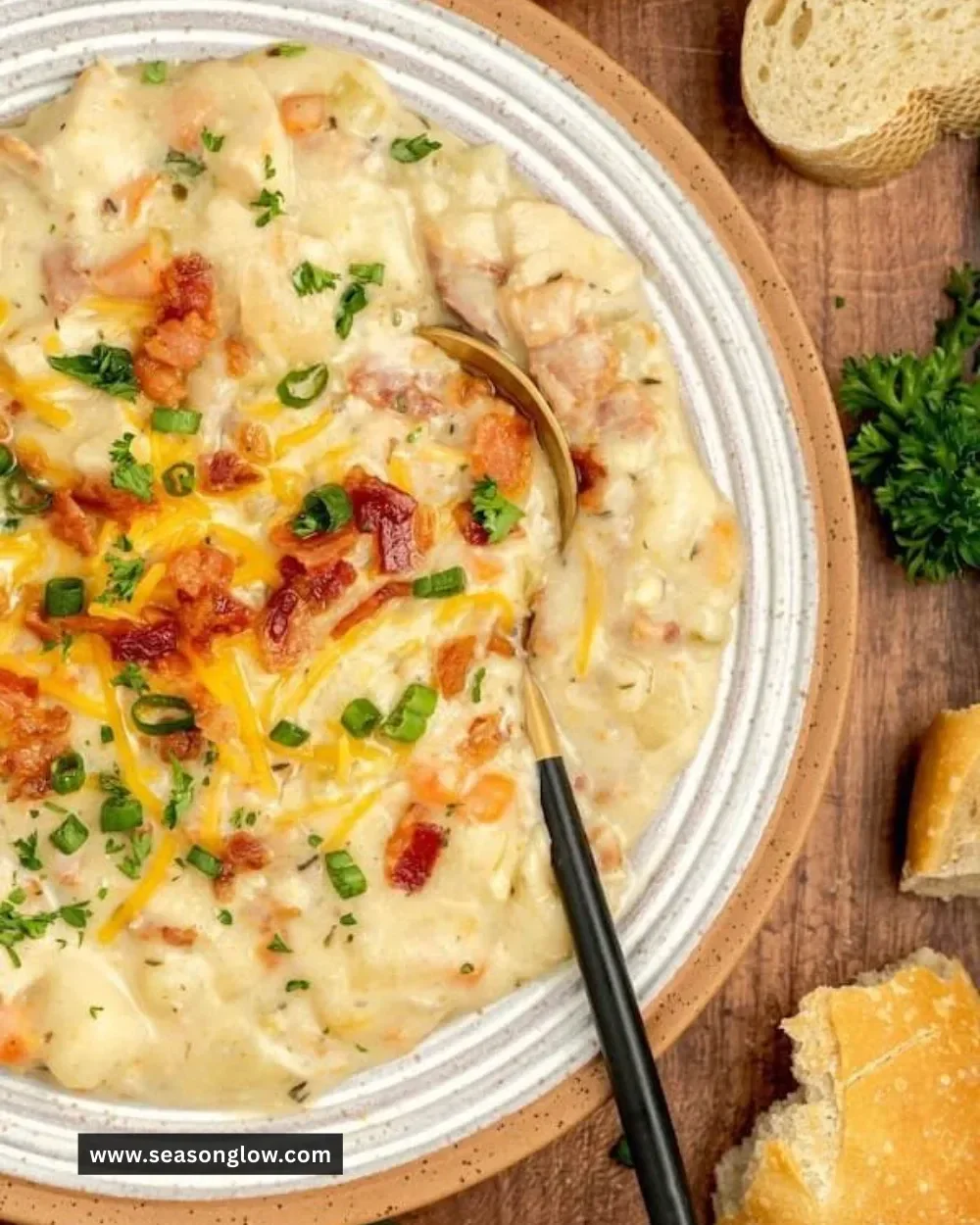 Bowl of creamy chicken and potato soup garnished with herbs