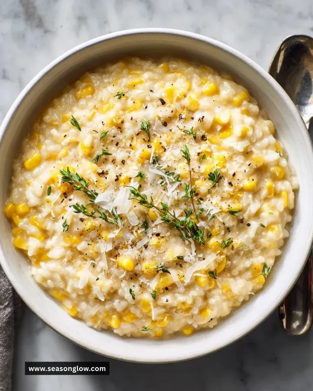 Creamy sweet corn risotto served with fresh herbs and parmesan cheese