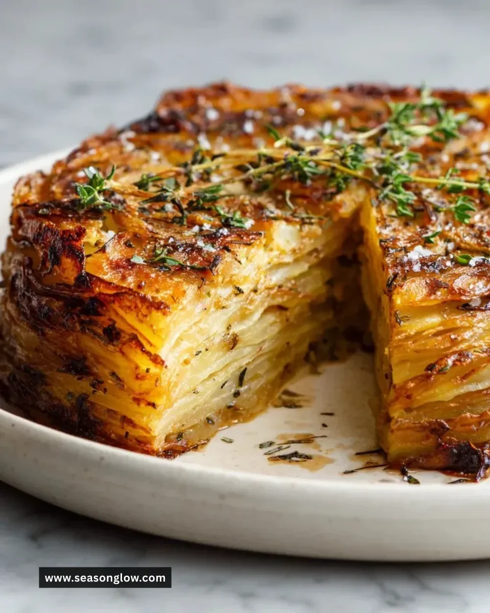 Crispy balsamic thyme potato torte garnished with fresh thyme leaves