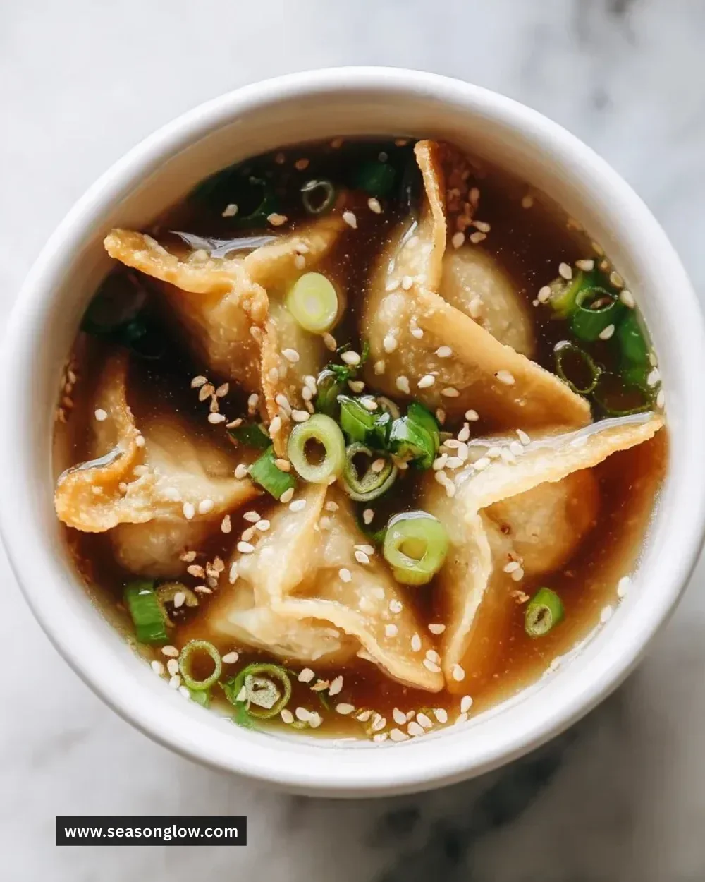 Bowl of easy potsticker soup with dumplings and green onions