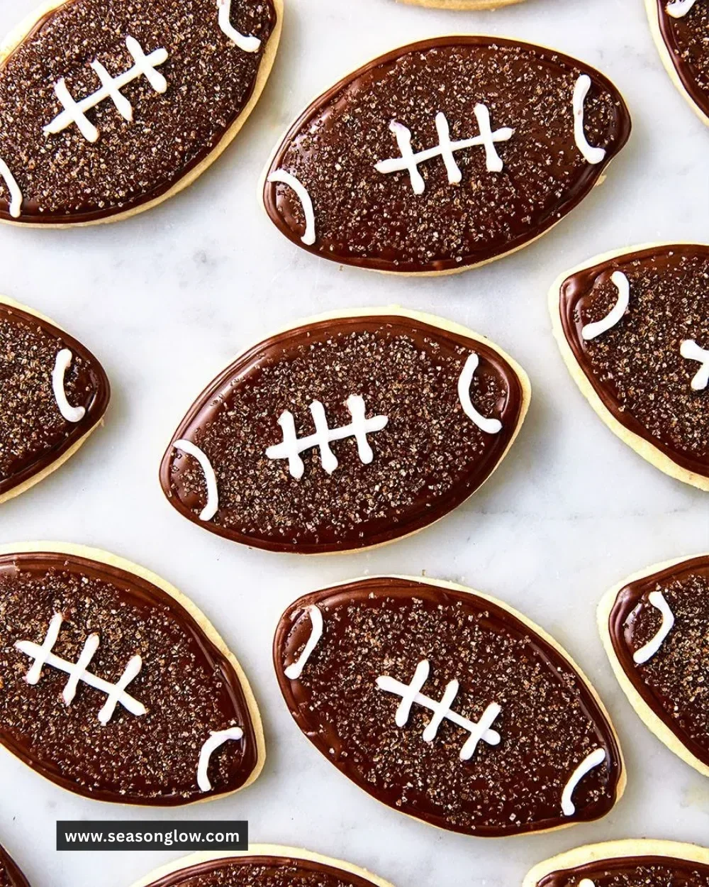 A plate of football-shaped cookies decorated for a game day celebration.