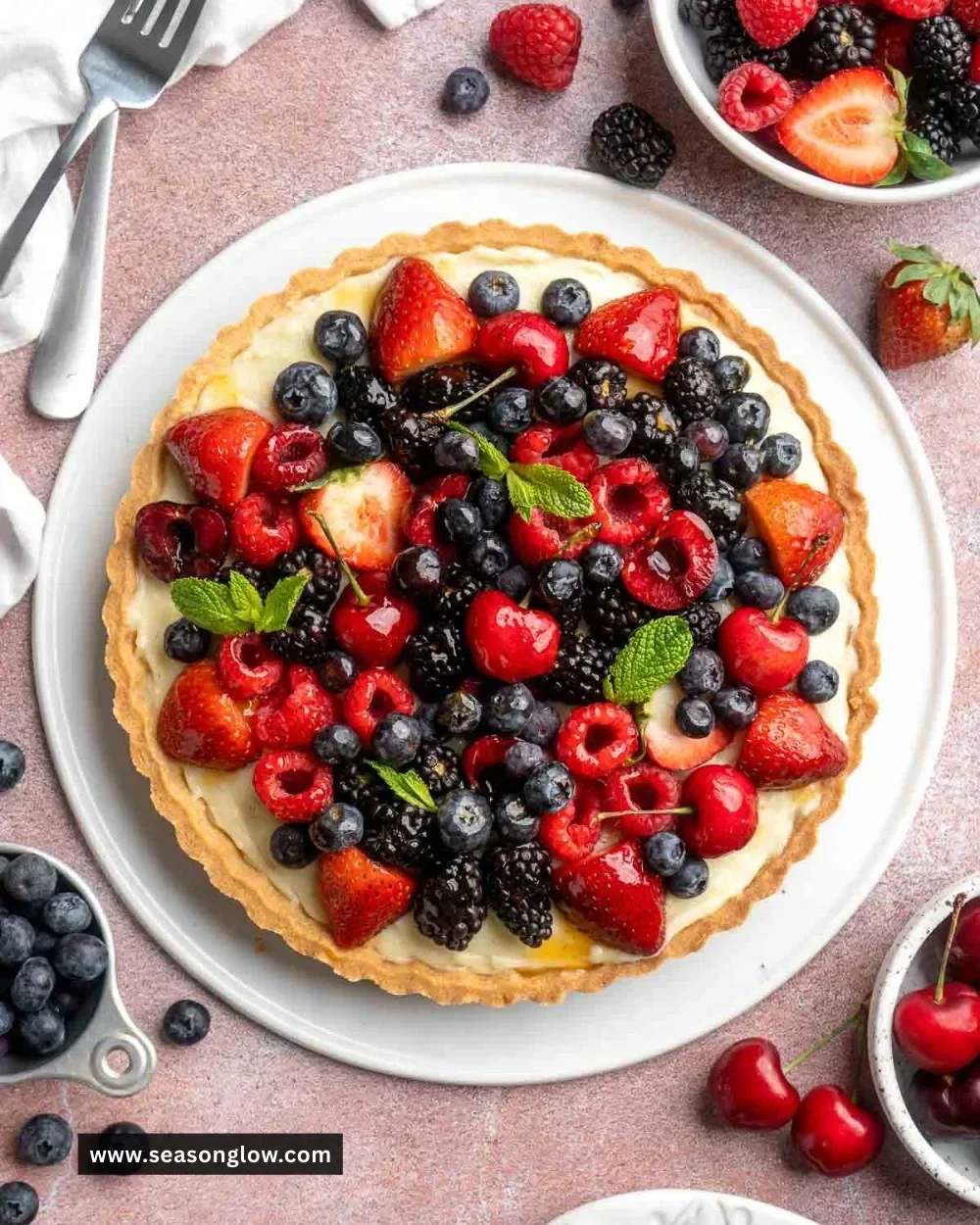 Fresh fruit tart topped with colorful seasonal fruits on a flaky crust