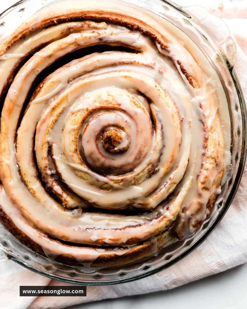 Delicious giant cinnamon roll cake on a serving plate