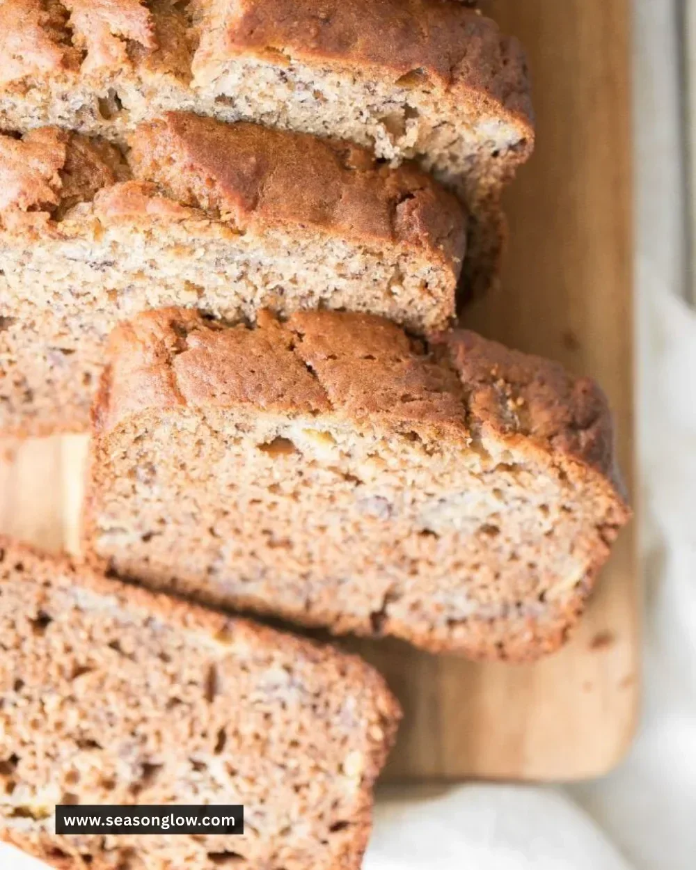 Delicious slice of healthy banana bread on a wooden table