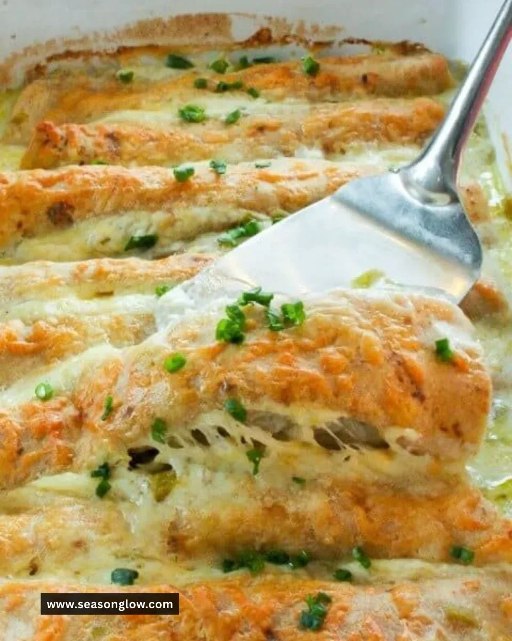 Healthy white chicken enchiladas topped with creamy sauce and garnished with cilantro