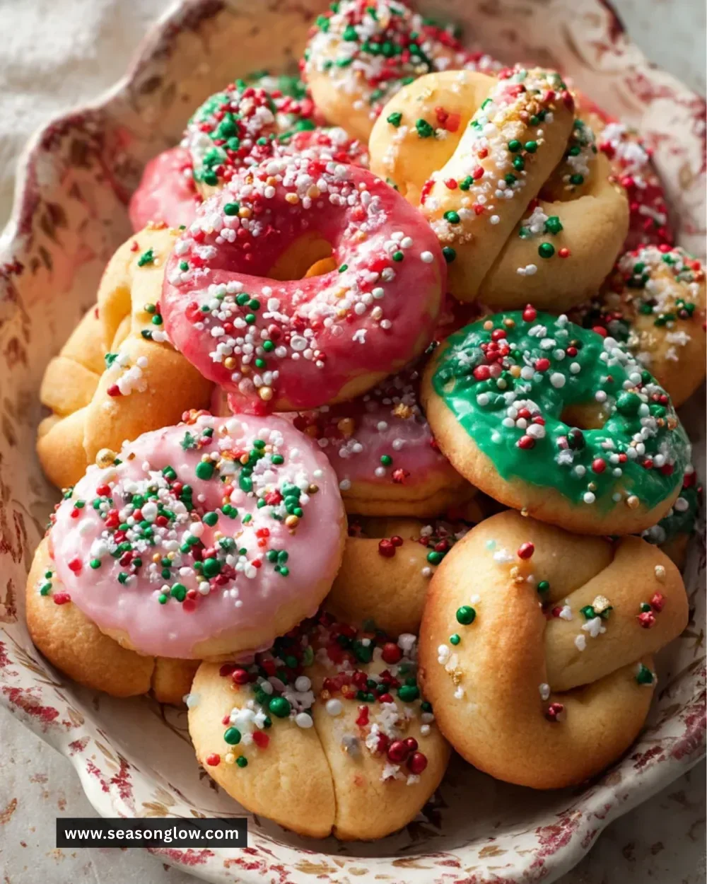 A plate of colorful Italian Christmas cookies decorated for the holidays.