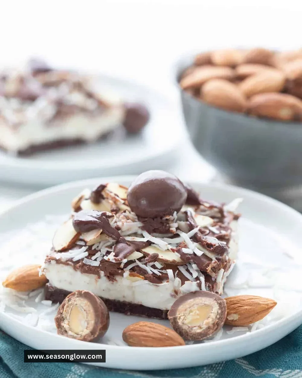Keto Almond Joy Cheesecake Bars topped with chocolate and almonds
