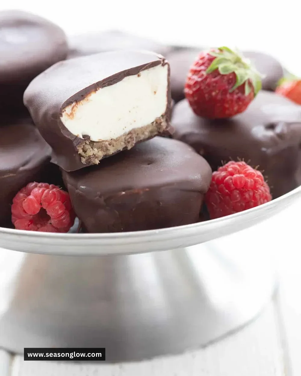 Keto Cheesecake Bites on a white plate garnished with berries