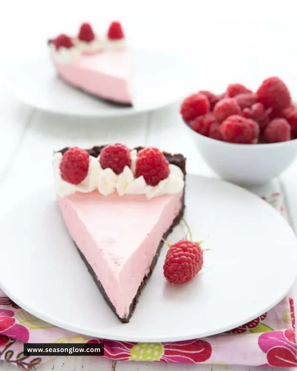 Delicious Keto Raspberry Mousse Tart topped with fresh raspberries