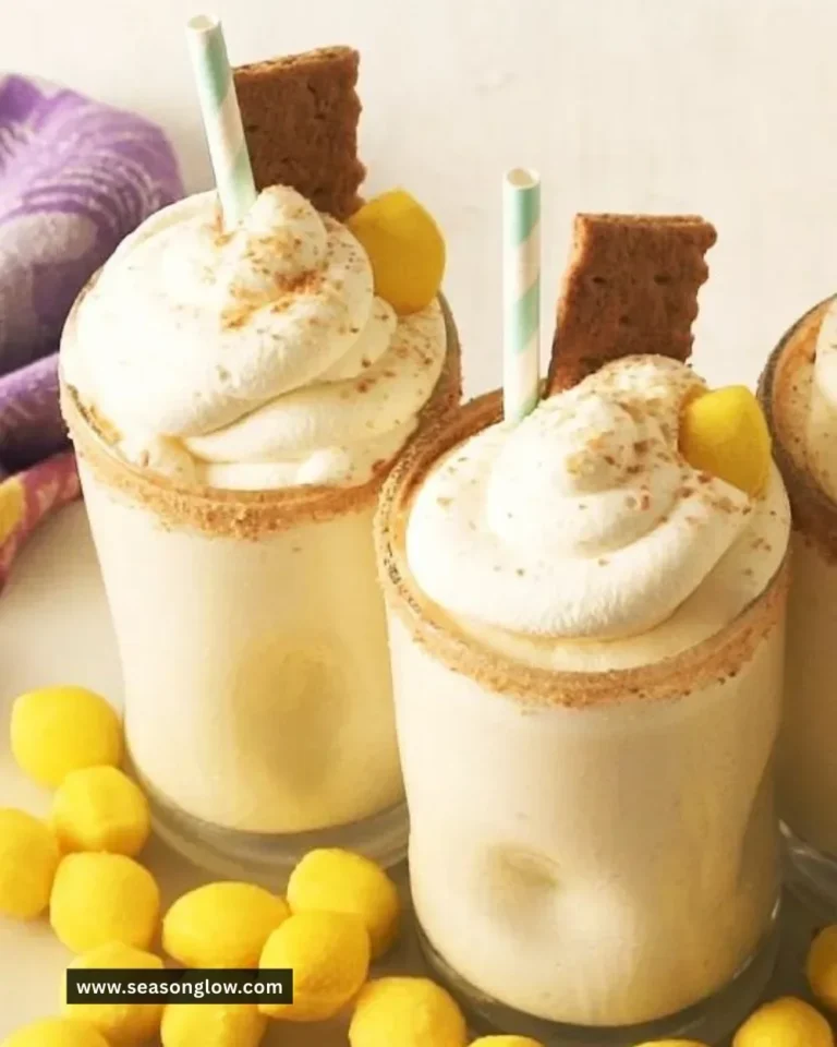 A refreshing Lemon Pie Milkshake topped with whipped cream and lemon slices