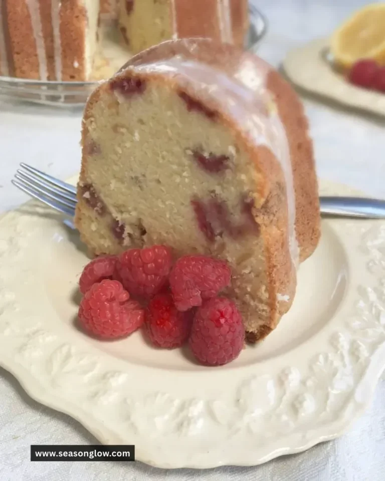Slice of Lemon Raspberry Pound Cake with raspberries and lemon slices