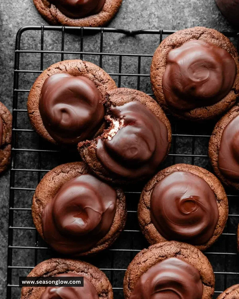 Delicious marshmallow-surprise hot cocoa cookies on a cooling rack.