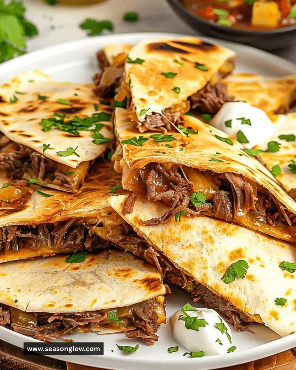 Mississippi pot roast quesadillas served on a plate with toppings.