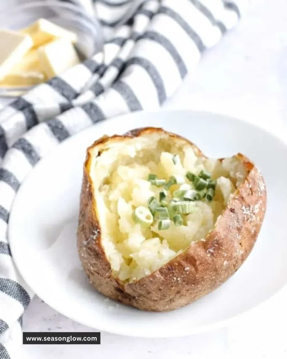 A perfectly cooked Ninja Foodi baked potato with crispy skin and fluffy interior.