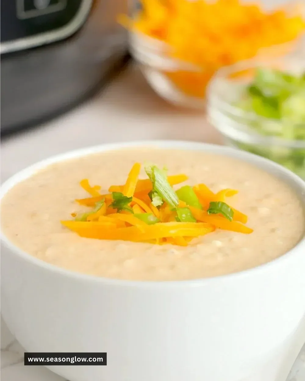 Creamy Ninja Foodi cheesy cauliflower soup in a bowl with garnish