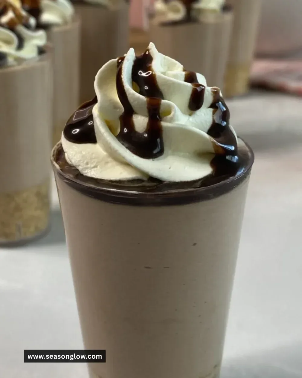 No-Bake Chocolate Milkshake Cheesecake Cups topped with chocolate drizzles