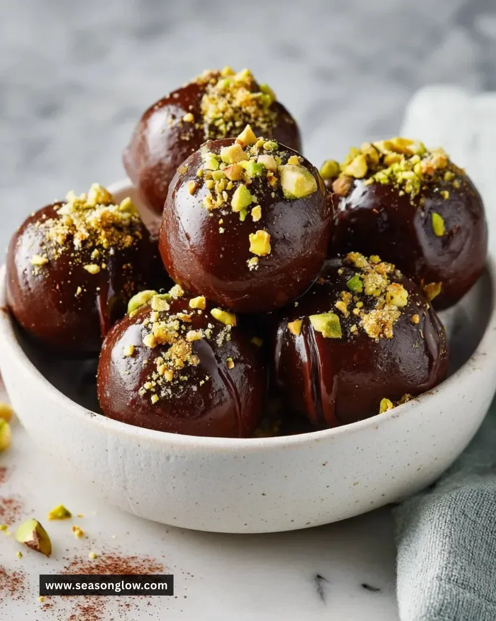 Delicious No-Bake Dubai Chocolate Balls adorned with nuts and cocoa powder.