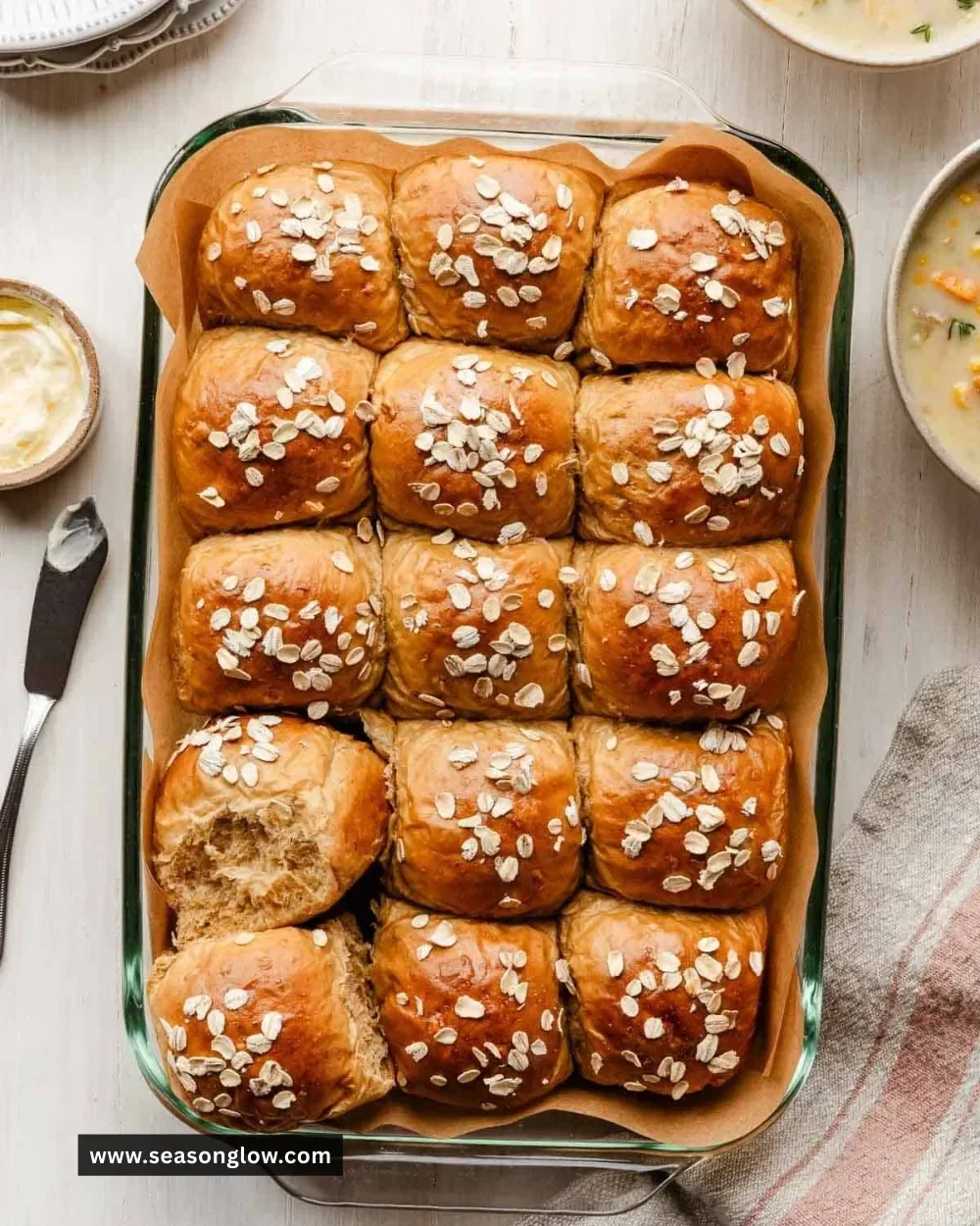 Freshly baked Oatmeal Molasses Dinner Rolls on a wooden table