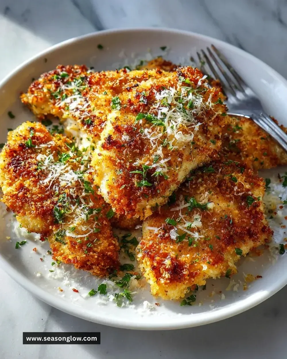 Delicious Parmesan Garlic Chicken garnished with fresh herbs